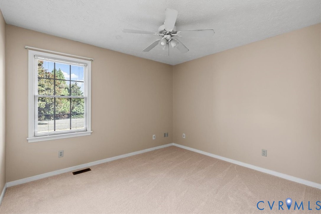 1437 Palmore Road Powhatan, VA 23139 - Photo 26 of 60 Neutral-toned walls complement plush carpeting