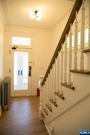 a view of an entryway with wooden floor