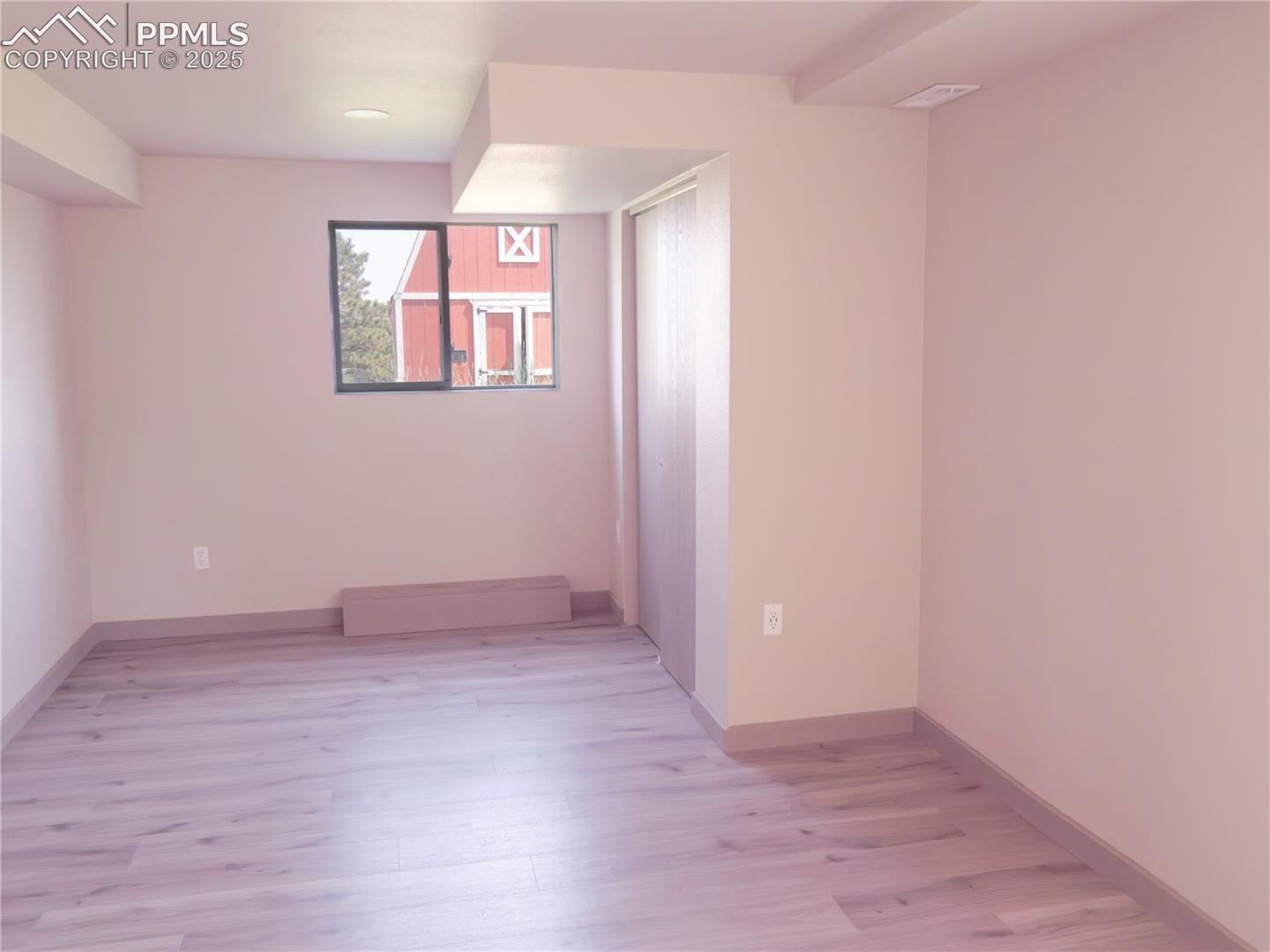 4130 Walker Road Colorado Springs, CO 80908 - Photo 23 of 39 Spare room featuring light wood-type flooring, a baseboard heating unit, and recessed lighting