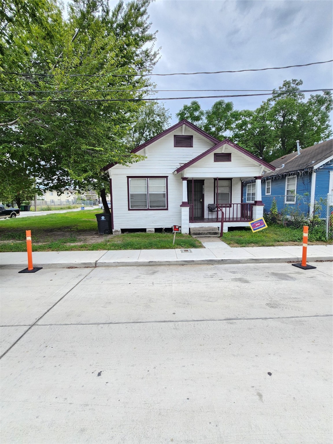 a front view of a house with a yard and potted plants