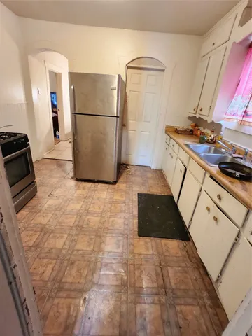 a kitchen with a refrigerator and a stove