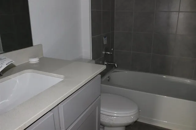 a kitchen with stainless steel appliances a refrigerator and a stove top oven