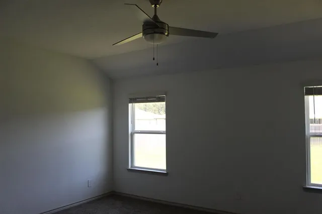 a kitchen with granite countertop a refrigerator and a stove top oven