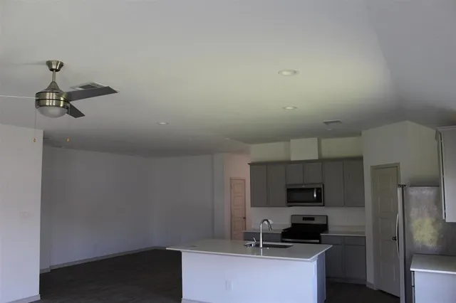 a kitchen with a sink a counter space and a window