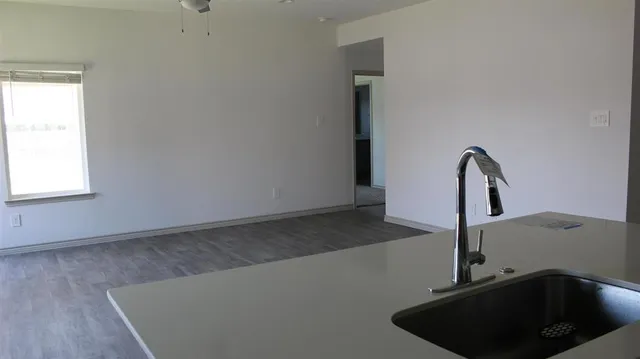 a kitchen with stainless steel appliances a stove a microwave and a sink