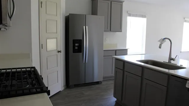 a kitchen with a sink and a refrigerator