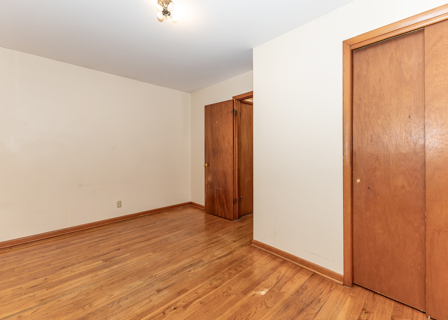 1608 3rd Street Camanche, IA 52730 - Photo 14 of 25 an empty room with wooden floor and windows