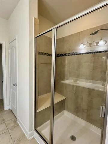 a bathroom with a glass shower door
