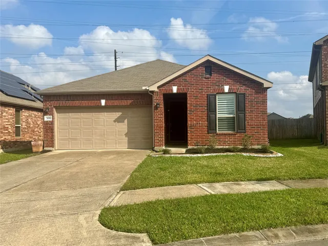 a view of a house with a yard and garage