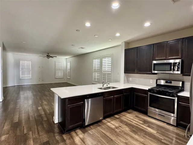 a kitchen with stainless steel appliances granite countertop a sink stove and oven