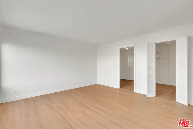 a view of an empty room and wooden floor