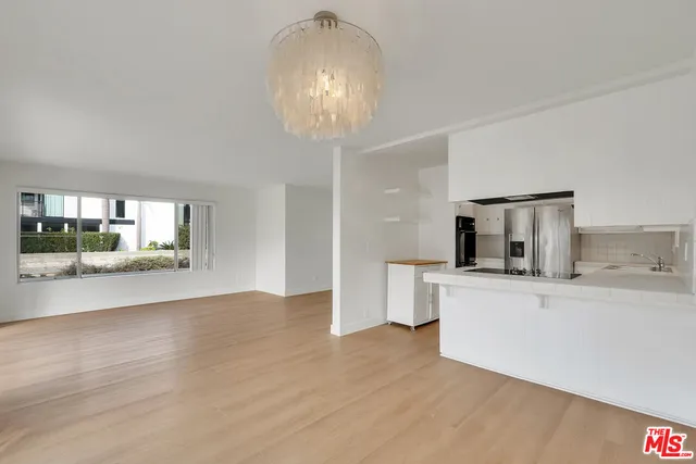 a kitchen with a sink and wooden floor