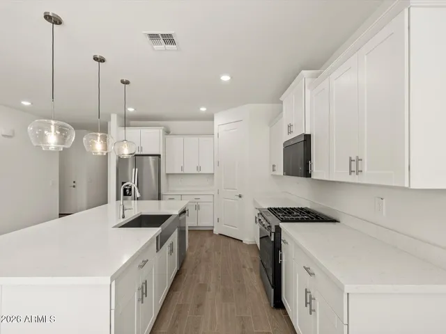 a kitchen that has a sink a counter space and a area