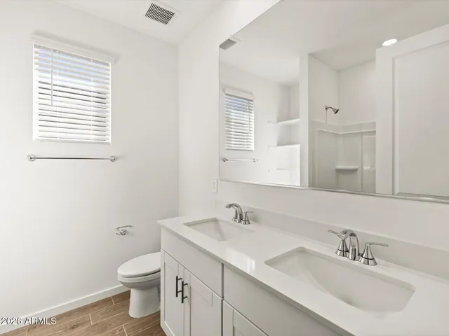 a bathroom with a sink toilet and mirror