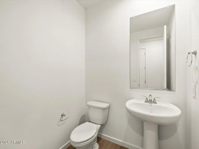 a bathroom with a sink a toilet and mirror