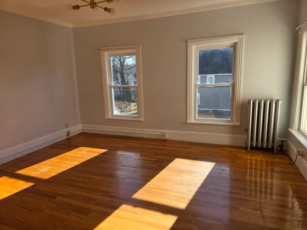 a view of a room with wooden floor and staircase
