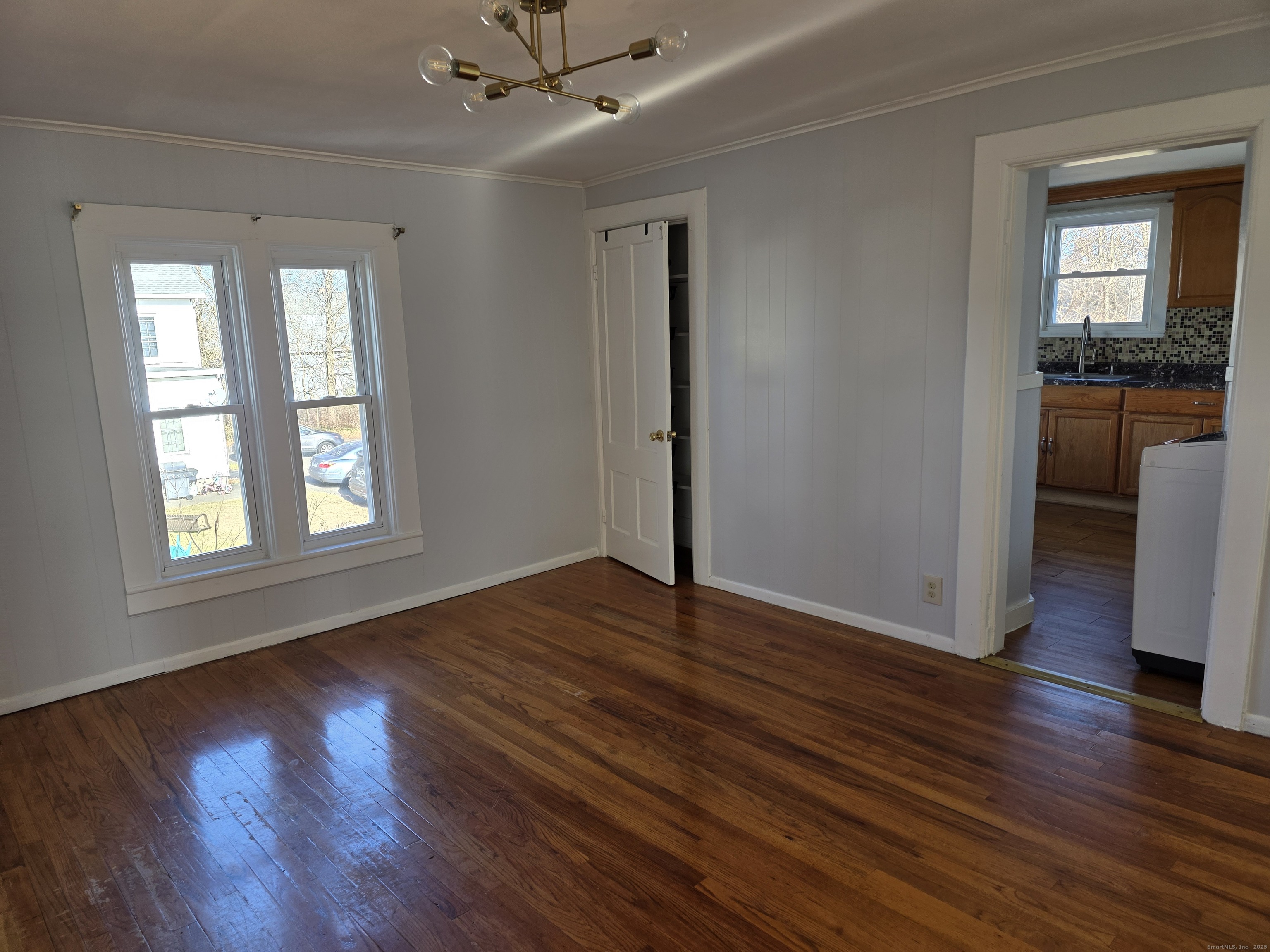 147 Pearl Street Enfield, CT 06082 - Photo 14 of 16 a view of an empty room with a window and wooden floor