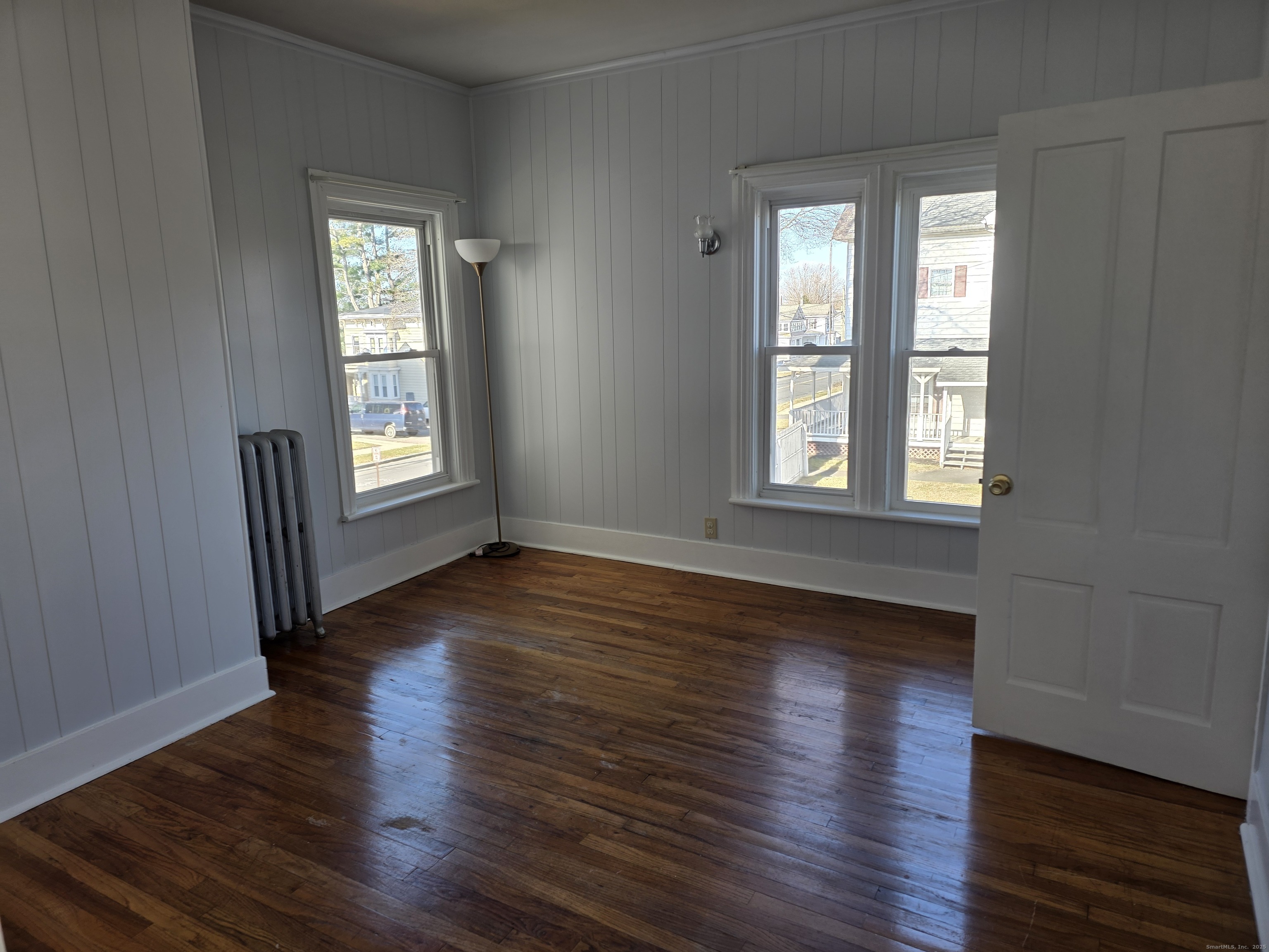 147 Pearl Street Enfield, CT 06082 - Photo 15 of 16 an empty room with wooden floor and windows