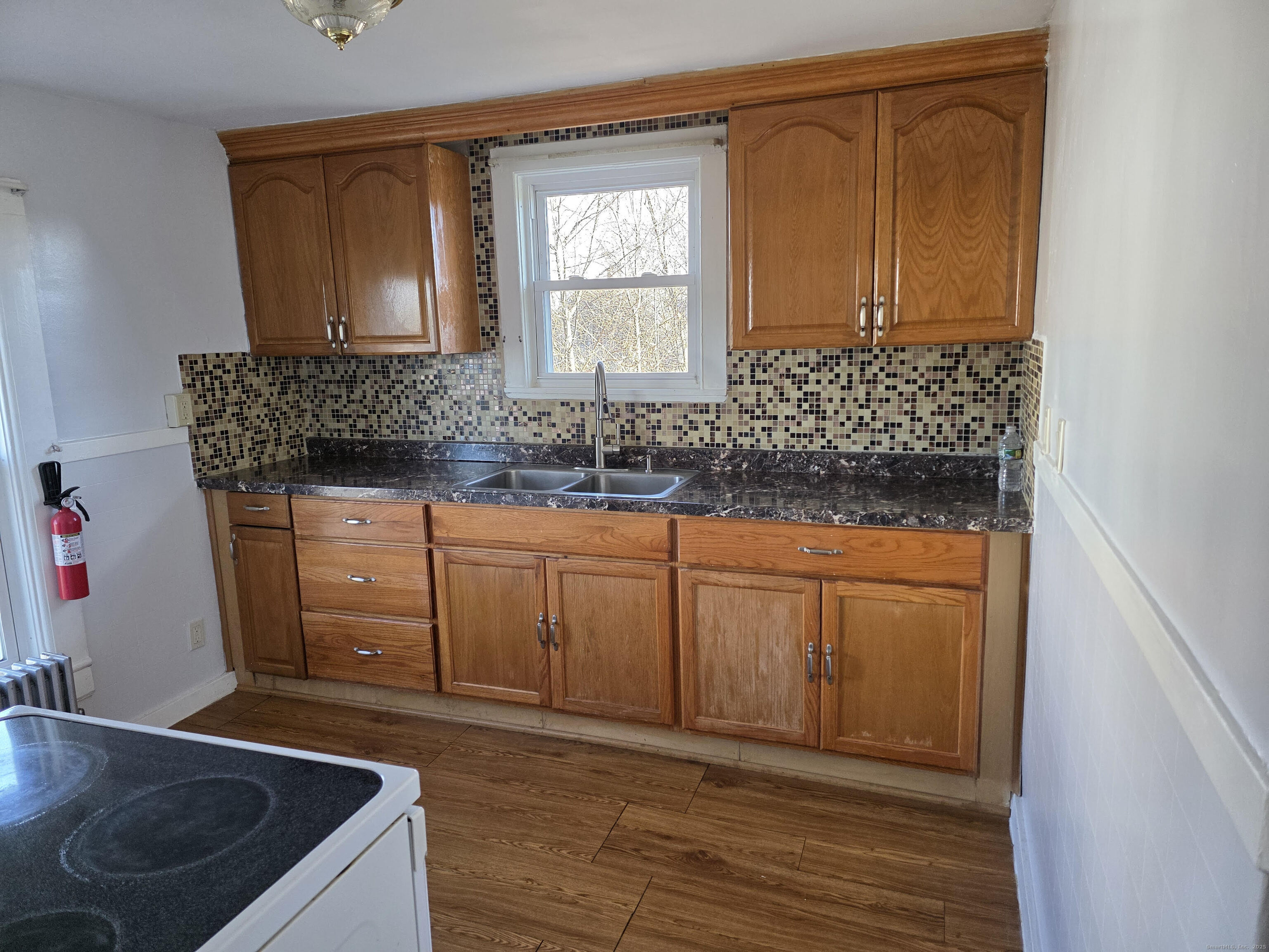 147 Pearl Street Enfield, CT 06082 - Photo 3 of 16 a bathroom with a sink and a mirror