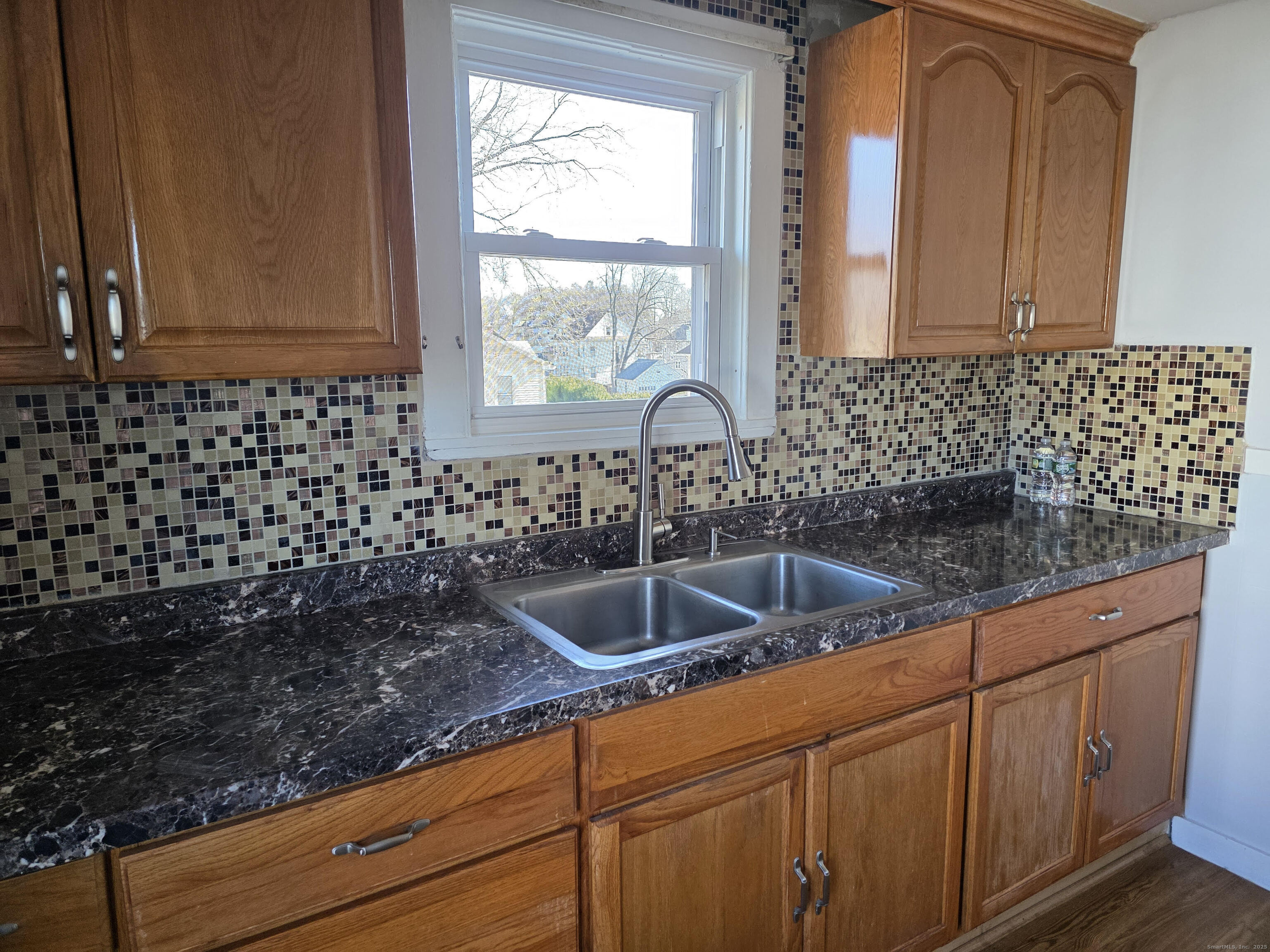 147 Pearl Street Enfield, CT 06082 - Photo 6 of 16 a kitchen with granite countertop a sink and a window