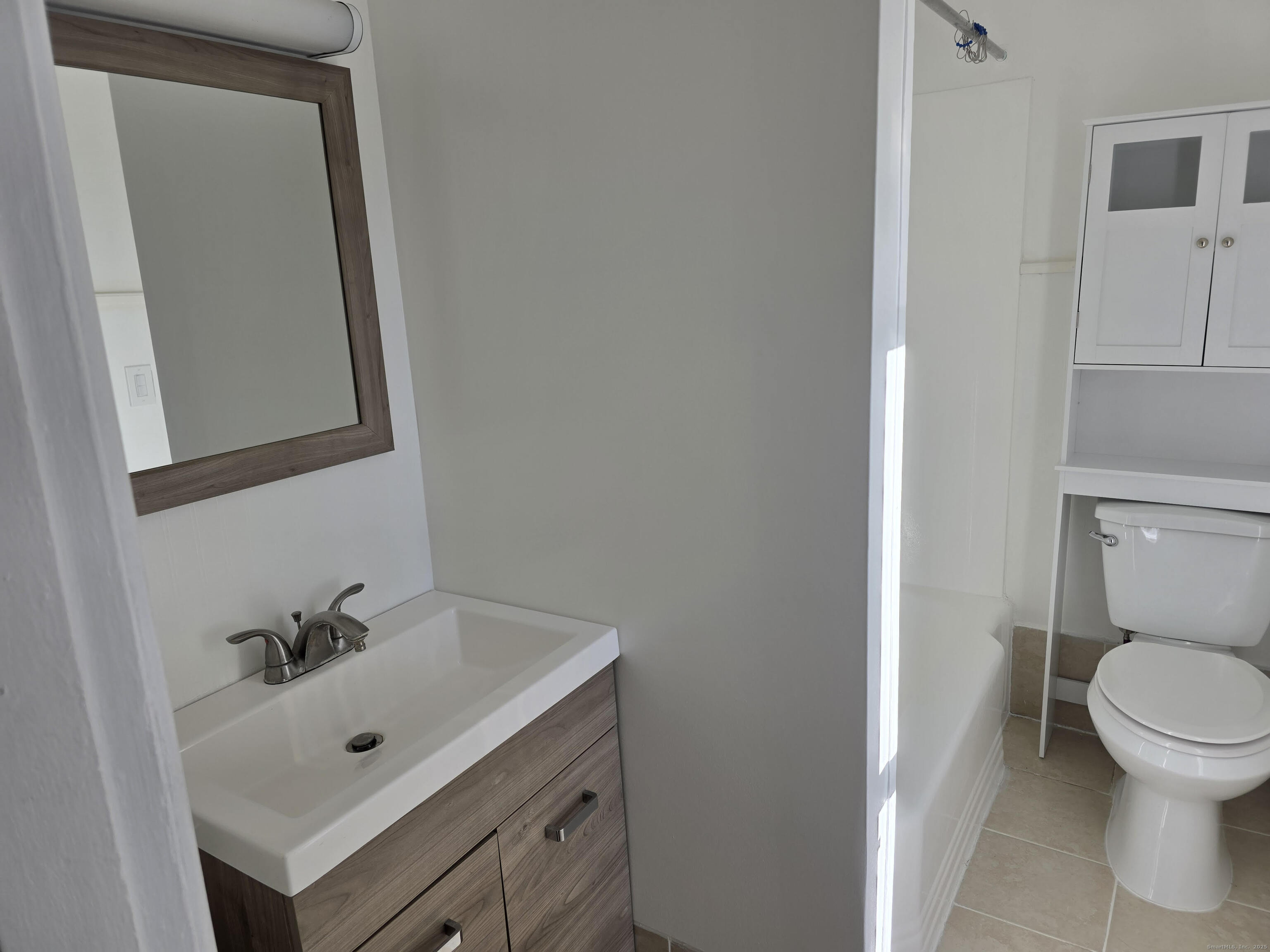 147 Pearl Street Enfield, CT 06082 - Photo 9 of 16 a bathroom with a sink a toilet and mirror