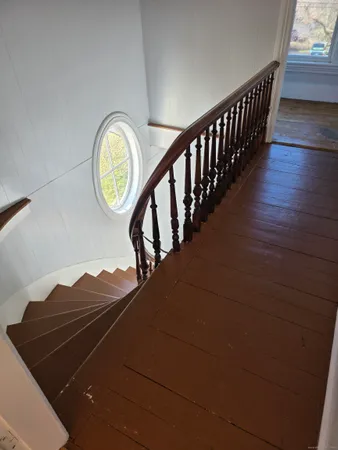 a view of staircase with wooden floor