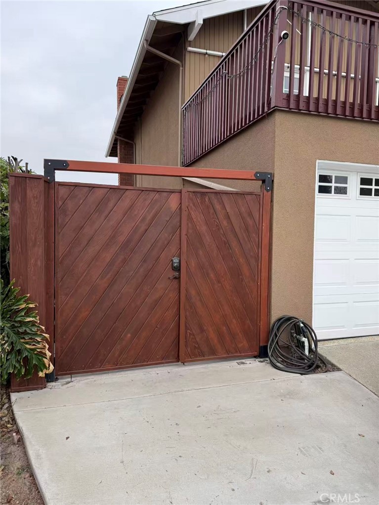 a view of a street with wooden fence