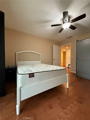 a spacious bedroom with a bed and a chandelier