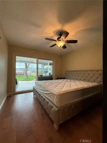 a spacious bedroom with a bed and a large window