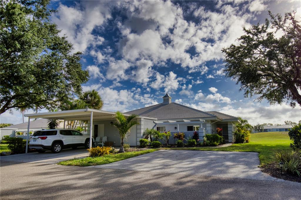208 Cerromar Way, Unit 26 Venice, FL 34293 - Photo 1 of 1 a front view of a house with a garden and pathway