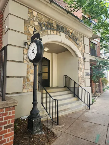 a view of a brick wall with a large tree