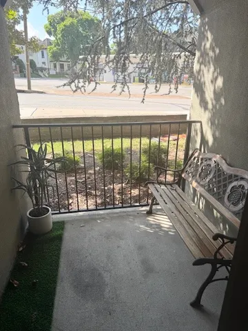 a living room with fireplace furniture and a large window