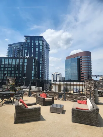 a roof deck with couch and potted plants