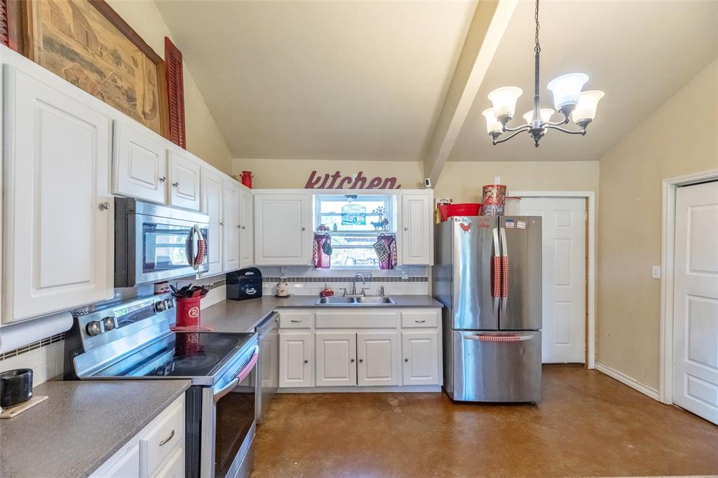 1502 Avenue North Anson, TX 79501 - Photo 15 of 20 a kitchen that has a lot of cabinets and stainless steel appliances