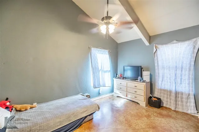 a bed room with a bed and a television