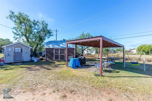 a view of a house with backyard porch and sitting area
