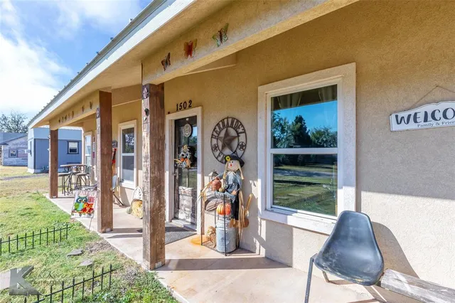 a front view of a house with outdoor seating