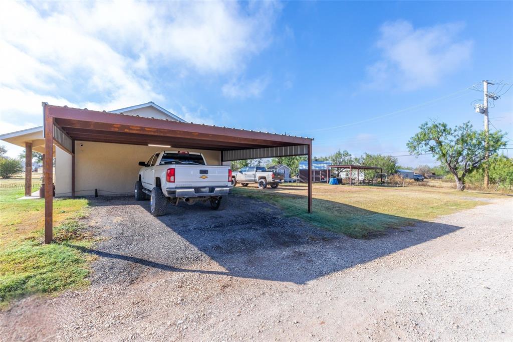 1502 Avenue North Anson, TX 79501 - Photo 3 of 20 a front view of a house with garden