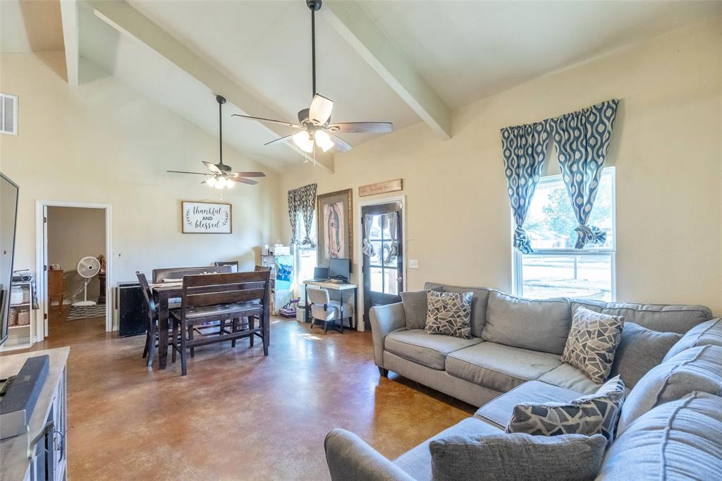 1502 Avenue North Anson, TX 79501 - Photo 6 of 20 a living room with furniture a dining table and a chandelier