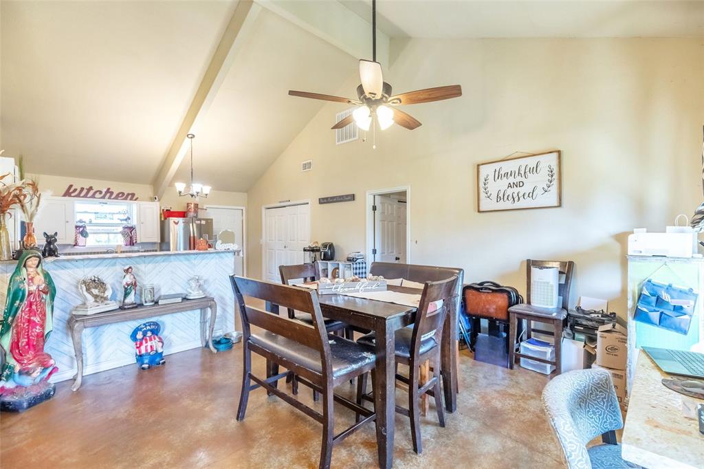 1502 Avenue North Anson, TX 79501 - Photo 7 of 20 a view of a dining room with furniture and a chandelier fan