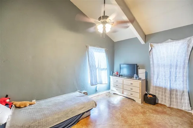 a bed room with a bed and a tv