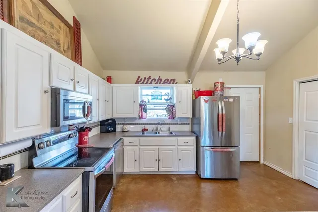 a kitchen filled counter top space and stainless steel appliances