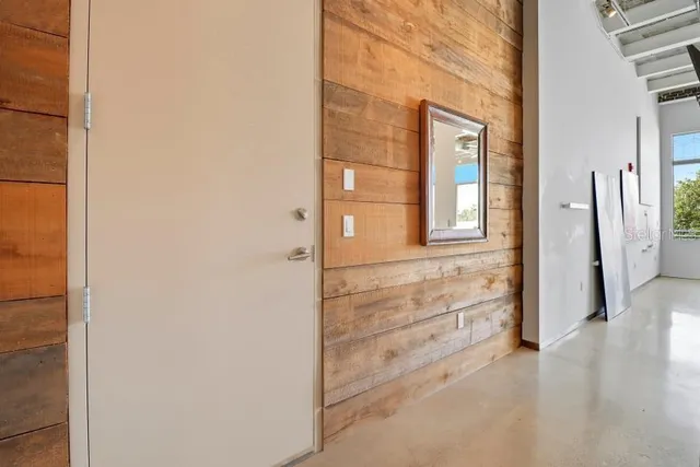 a view of a hallway with bathroom and wooden floor