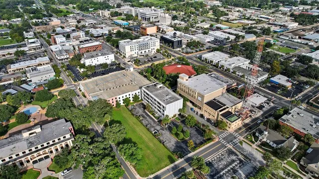 a front view of residential houses with yard and trees
