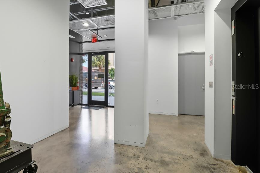 302 Southeast Broadway Street, Unit 460 Ocala, FL 34471 - Photo 7 of 47 a view of a hallway with wooden floor and windows