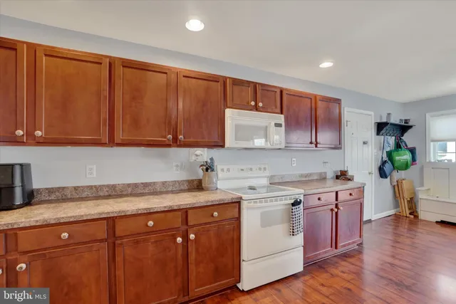 a kitchen with a sink cabinets and wooden floor
