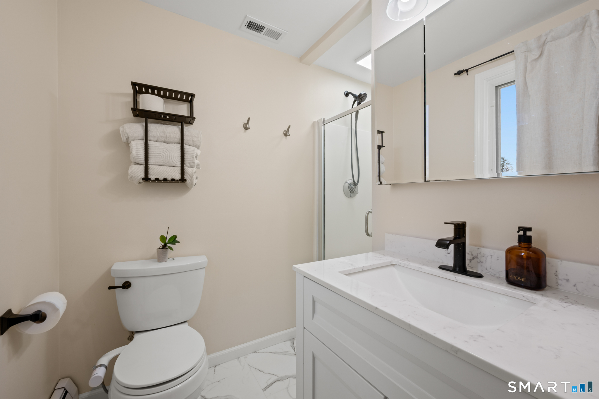 201 Ridge Crest Circle Wethersfield, CT 06109 - Photo 18 of 35 a bathroom with a toilet a sink and mirror