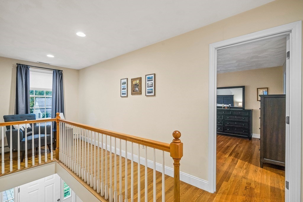 53 Elder Road Needham, MA 02494 - Photo 12 of 33 a view of hallway with wooden floor