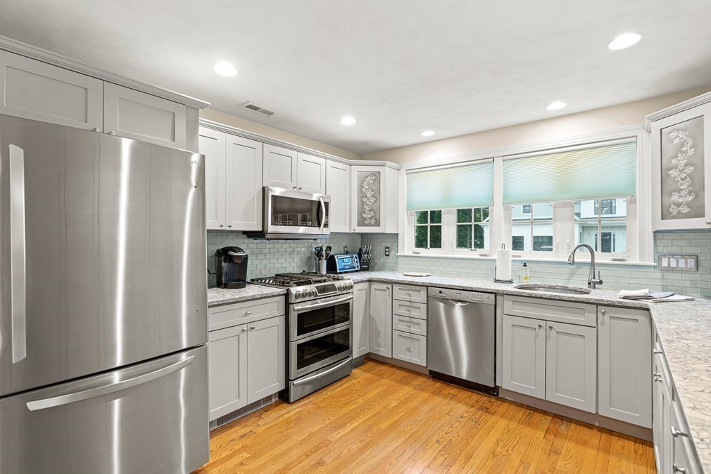 53 Elder Road Needham, MA 02494 - Photo 6 of 33 a kitchen with a sink stainless steel appliances and white cabinets