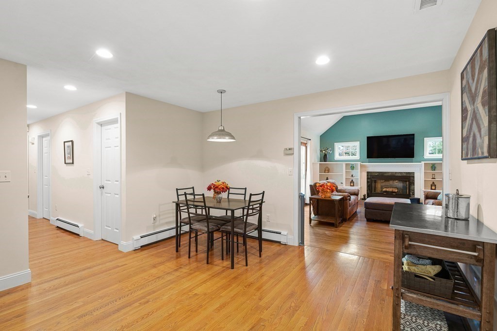 53 Elder Road Needham, MA 02494 - Photo 8 of 33 a view of a dining room with furniture wooden floor and a flat screen tv